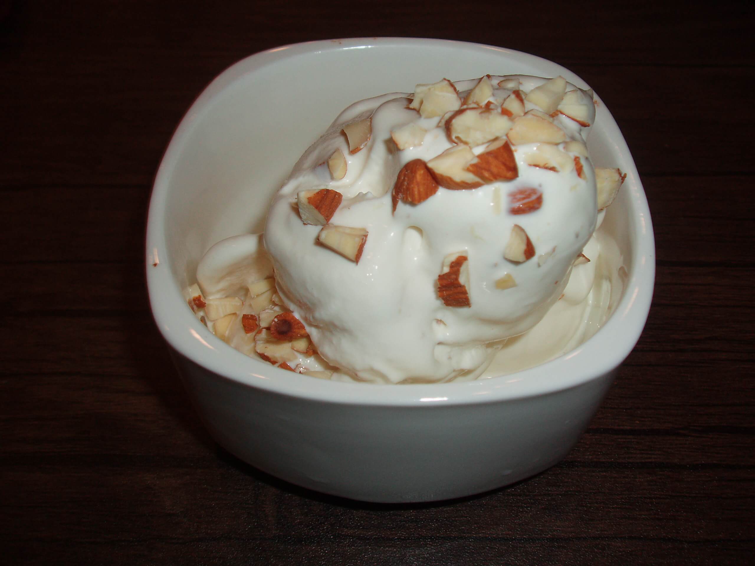 Homemade ice cream a cup of Qulfa Ice Cream topped with Almonds